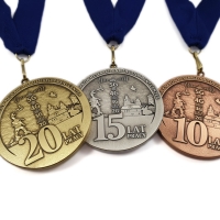 medale tłoczone z mosiądzu; średnica 70 mm; wykończenie w trzech kolorach; medale wieszane na tasiemce; medale bite dla Nokia Kraków Research And Development Center